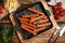 Tasty grilled sausages served on wooden table