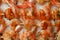 Tasty grilled shrimp skewers on baking paper, close up