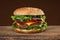 Tasty hamburger on wood background