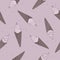 Tasty hand drawn ice creams in waffle cone with dark spots on pale pink background. Seamless summer food pattern