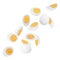 Tasty hard boiled eggs falling on white background