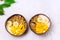 Tasty and Healthy Breakfast in Coconut Bowls Granola With Yogurt Banana and Mango Top View Horizontal Copy Space