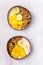 Tasty and Healthy Breakfast in Coconut Bowls Granola With Yogurt Banana and Mango Top View Vertical