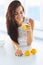 Tasty healthy breakfast. Woman drinking orange juice and smiling