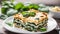 Tasty healthy portion of vegetarian spinach lasagne with tofu and pesto