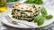 Tasty healthy portion of vegetarian spinach lasagne with tofu and pesto