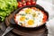 Tasty and Healthy Shakshuka in a Frying Pan. Fried eggs with tom