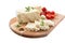 Tasty healthy sheep or goat feta cheese. Chunks of cheese on a wooden board isolated on white