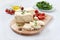 Tasty healthy sheep or goat feta cheese. Chunks of cheese on a wooden board on white background