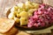 Tasty herring salad with vegetables and a side dish of boiled potatoes close-up in a plate. horizontal