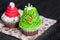 Tasty holiday cupcakes on a dark background