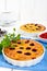 Tasty homemade berry pies in a round ceramic form