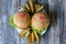 Tasty homemade cheeseburgers with mustard, tomatoes and green lettuce. Sesame burgers with red hearts and potato wedges on wooden