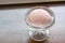 The tasty homemade cool strawberry ice cream scoop in glass cup on wood table