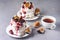 Tasty Homemade Dessert Mini Pavlova Cakes with Figs and Berry Homemade Pavlova Cake on Gray Background with Cup of Tea Horizontal