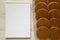 Tasty homemade dutch stroopwafels with honey-caramel filling, blank notepad on a white wooden background, top view. Flat lay,