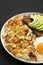 Tasty Homemade Fried Hashbrowns and Eggs on a plate on a black background, low angle view