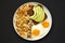 Tasty Homemade Fried Hashbrowns and Eggs on a plate on a black surface, top view. Flat lay, overhead, from above