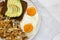 Tasty Homemade Fried Hashbrowns and Eggs on a plate on a white wooden background, top view. Flat lay, overhead, from above. Copy