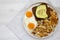 Tasty Homemade Fried Hashbrowns and Eggs on a plate on a white wooden background, top view. Flat lay, overhead, from above. Space