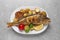 Tasty homemade roasted perch with garnish on grey table, top view. River fish