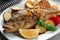 Tasty homemade roasted perch with garnish on table, closeup. River fish