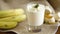 Tasty homemade yogurt with bananas in a glass on a wooden table