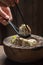 Tasty and hot manti dumplings in wooden bowl