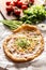 Tasty hungarian langos served with sour creme, ham, cheese, herbs and vegetables in the background