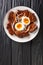 Tasty Kakuni Japanese Simmered Pork Belly with boiled eggs close up in the plate. Vertical top view