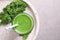 Tasty kale smoothie on light grey marble table, top view. Space for text