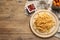 Tasty ketchup, fries and chicken nuggets on wooden table, flat lay. Space for text