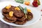 Tasty liver cutlets with tangerines on a white plate on the table