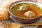 Tasty Liver dumplings added to broth make a wonderful authentic German soup close-up in a plate. horizontal