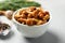 Tasty marinated mushrooms in bowl on grey table, closeup