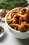 Tasty marinated mushrooms in bowl on grey table, closeup