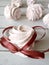 Tasty marshmallows tied with string on white wooden table