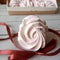 Tasty marshmallows tied with string on white wooden table