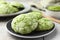 Tasty matcha cookies on tiled table, closeup