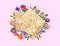 Tasty matzos and flowers on pink background, flat lay. Passover Pesach celebration