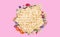 Tasty matzos and flowers on pink background, flat lay. Passover Pesach celebration