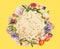 Tasty matzos and flowers on yellow background, flat lay. Passover Pesach celebration