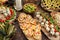 Tasty meals on a brown rustic wooden banquet table.