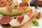 Tasty melon, jamon and figs served on parchment, closeup