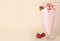 Tasty milk shake in glass and strawberries on background. Space for text