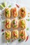 Tasty mini hot dogs with herbs and mustard
