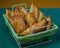 Tasty Mixed Spanish Empanadillas or spanish small pasties on a green tablecloth and a basket