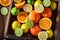 Tasty oranges, limes and lemons with on rustic table
