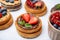 Tasty organic rusks with different toppings on light grey table, closeup