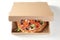 Tasty oven-fired Italian pizza in a fast food box